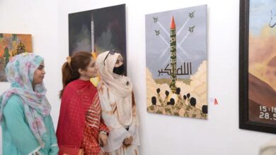 Women viewing painting during exhibition on the occasion of Youm e Takbir at Al-Hamra hall Lahore.